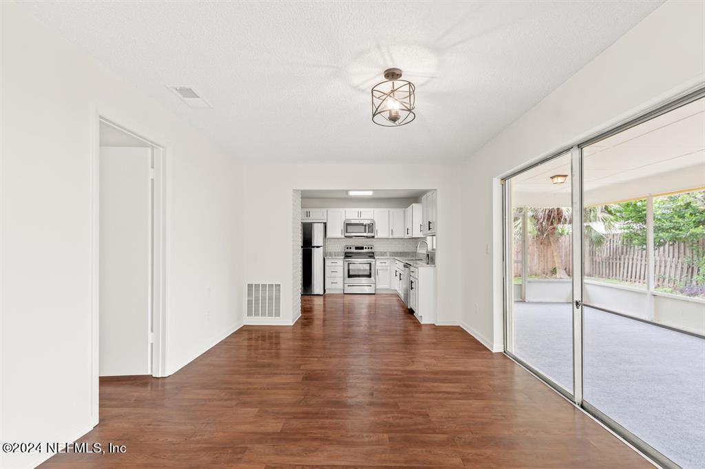 968 Espinado Avenue St. Augustine, FL 32086 - Photo 8 of 36 a view of a room with wooden floor and windows