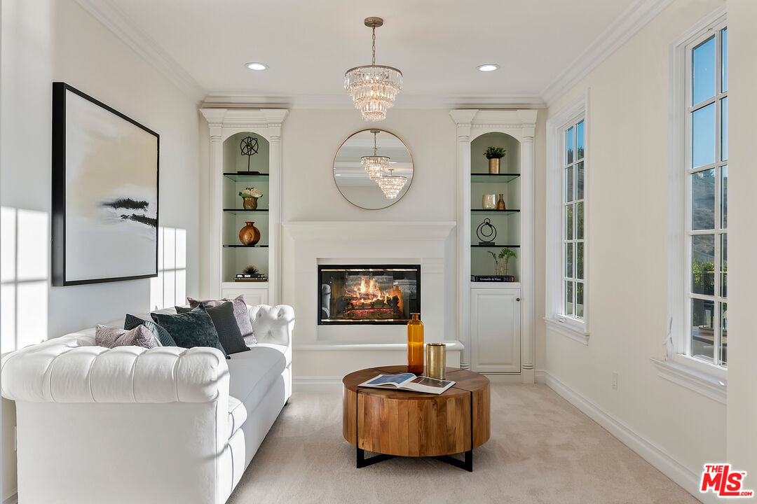 25430 Prado De Azul Calabasas, CA 91302 - Photo 23 of 51 a living room with furniture a clock and a fireplace