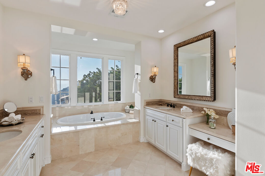 25430 Prado De Azul Calabasas, CA 91302 - Photo 24 of 51 a bathroom with a tub double vanity sink and mirror