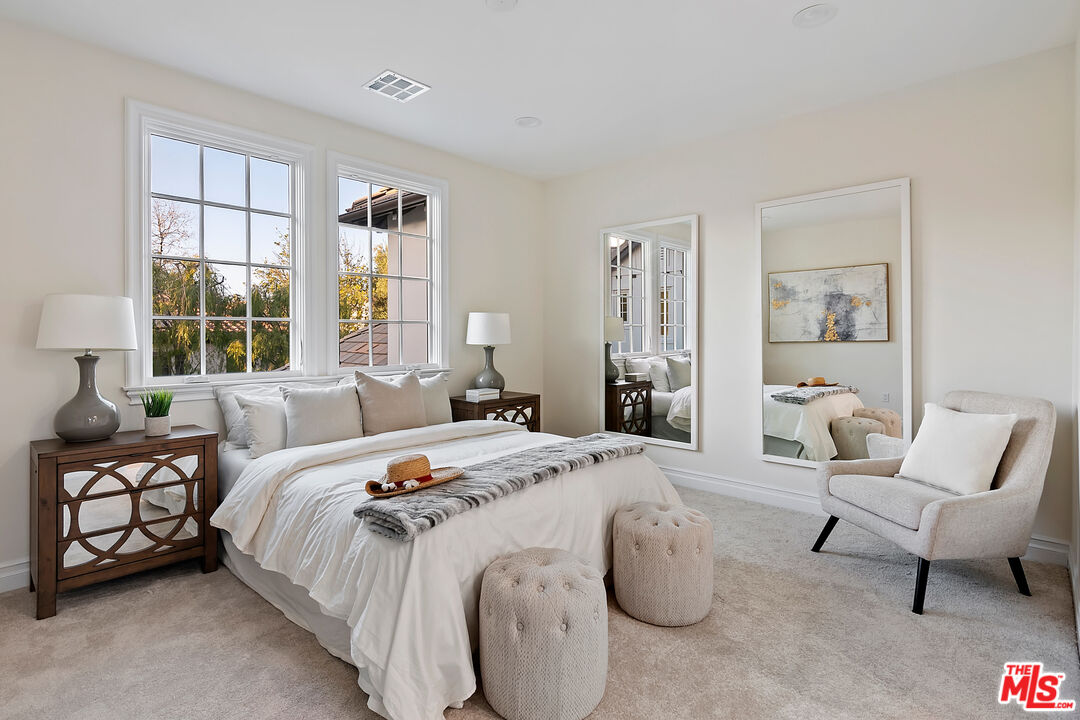 25430 Prado De Azul Calabasas, CA 91302 - Photo 29 of 51 a bedroom with a bed and a couch next to a window