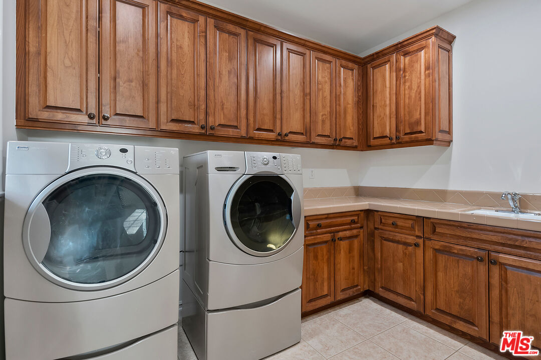 25430 Prado De Azul Calabasas, CA 91302 - Photo 33 of 51 a utility room with sink dryer and washer