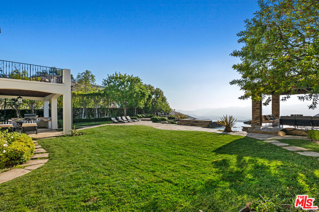 25430 Prado De Azul Calabasas, CA 91302 - Photo 37 of 51 a view of a house with a big yard potted plants and large tree