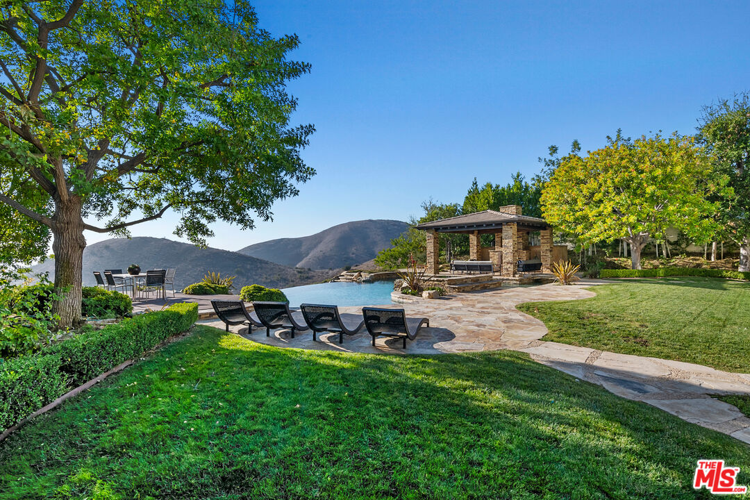 25430 Prado De Azul Calabasas, CA 91302 - Photo 38 of 51 a view of a house with backyard sitting area and garden