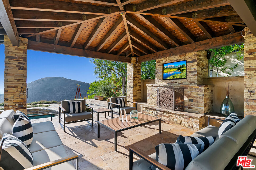 25430 Prado De Azul Calabasas, CA 91302 - Photo 42 of 51 a patio with a table and chairs