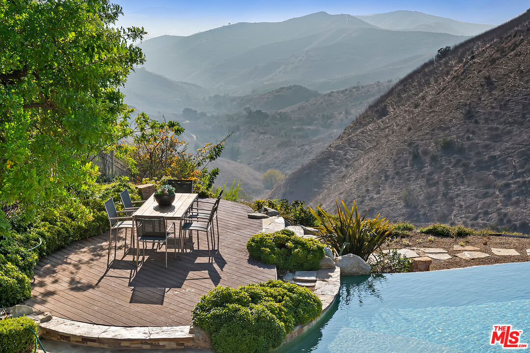 25430 Prado De Azul Calabasas, CA 91302 - Photo 44 of 51 a view of a backyard with table and chairs and potted plants