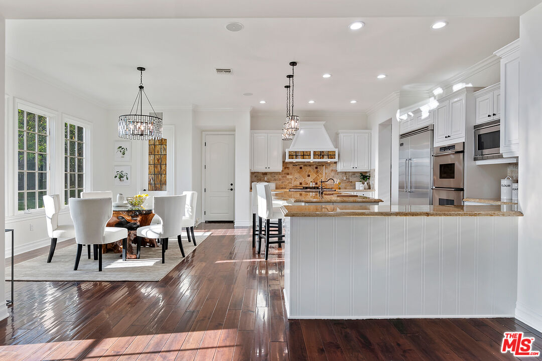 25430 Prado De Azul Calabasas, CA 91302 - Photo 6 of 51 a living room with stainless steel appliances kitchen island granite countertop furniture a rug kitchen view and a chandelier