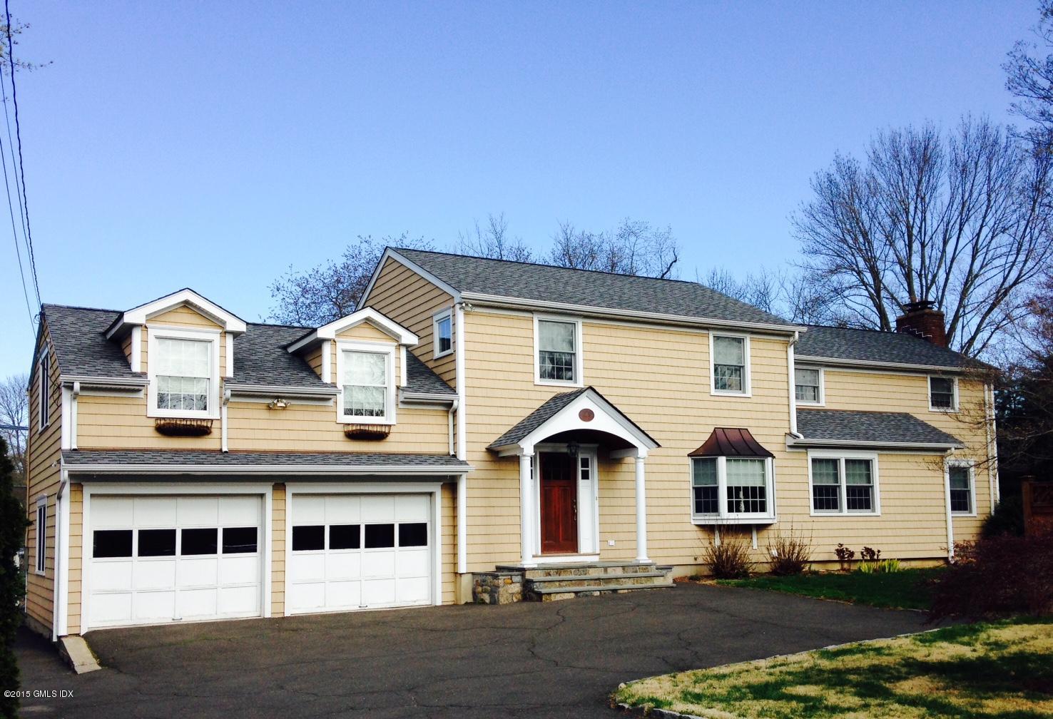 16 Orchard Street Cos Cob, CT 06807 - Photo 1 of 24 a front view of a house with a yard