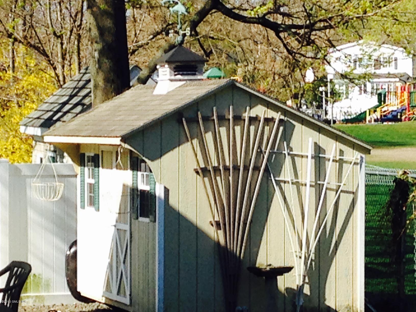 16 Orchard Street Cos Cob, CT 06807 - Photo 17 of 24 a front view of a house with a yard
