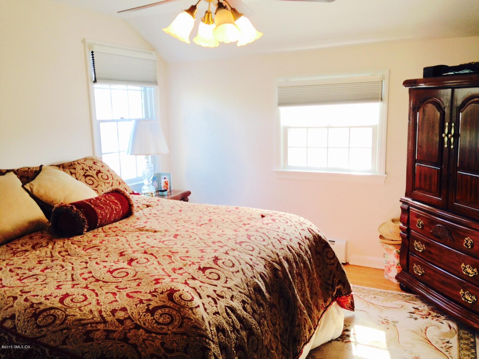 16 Orchard Street Cos Cob, CT 06807 - Photo 18 of 24 a bedroom with a bed and wooden floor