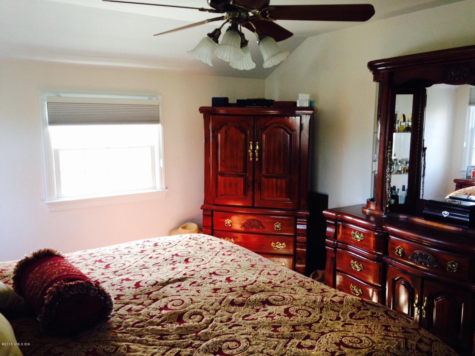 16 Orchard Street Cos Cob, CT 06807 - Photo 19 of 24 a bedroom with a bed and a dresser