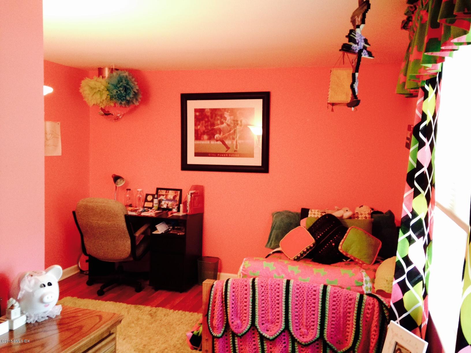 16 Orchard Street Cos Cob, CT 06807 - Photo 22 of 24 a bedroom with a bed and a painting on the wall