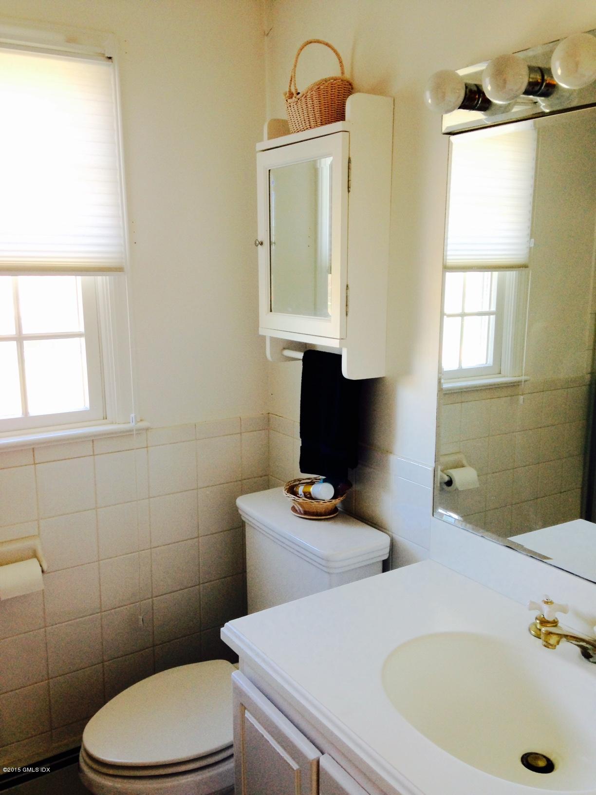 16 Orchard Street Cos Cob, CT 06807 - Photo 23 of 24 a bathroom with a sink a toilet and tub