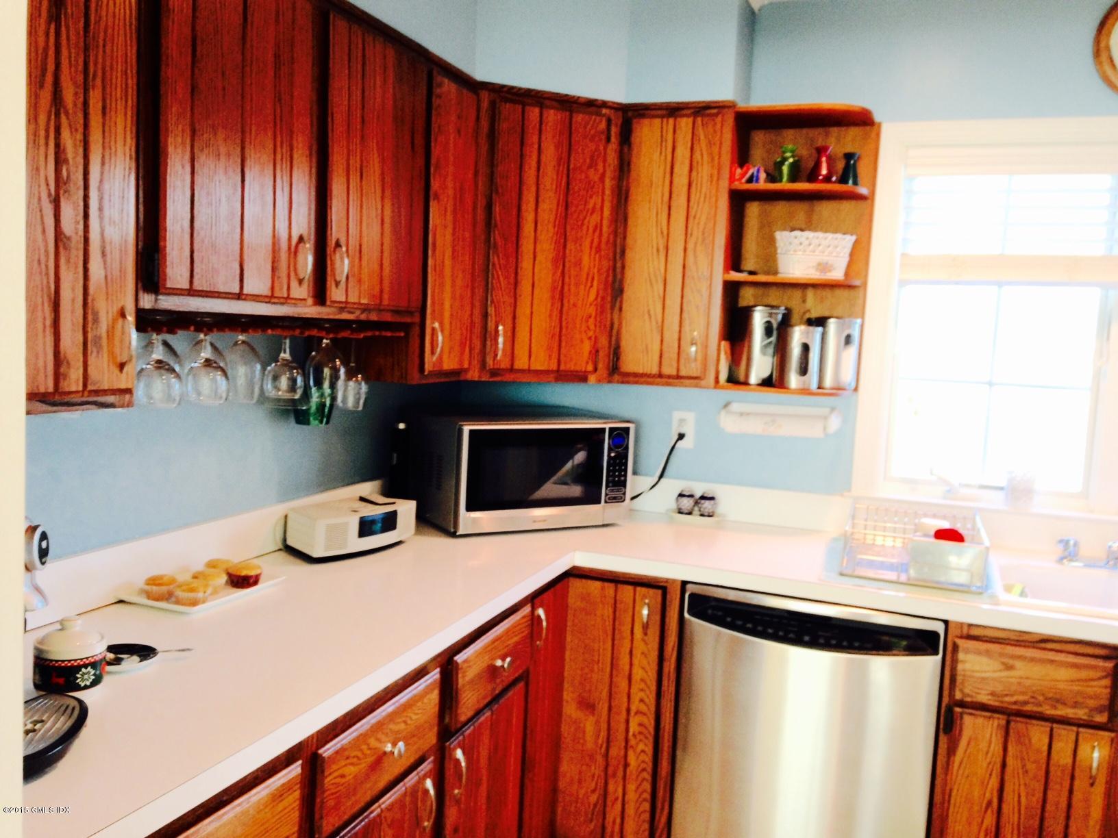 16 Orchard Street Cos Cob, CT 06807 - Photo 9 of 24 a kitchen with stainless steel appliances a sink a stove and a microwave