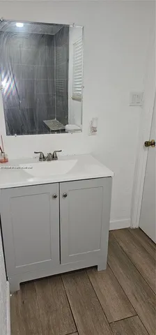 a room with a sink washer and dryer