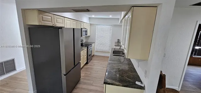 a view of hallway with wooden floor