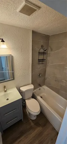 a bathroom with a sink a toilet and bathtub