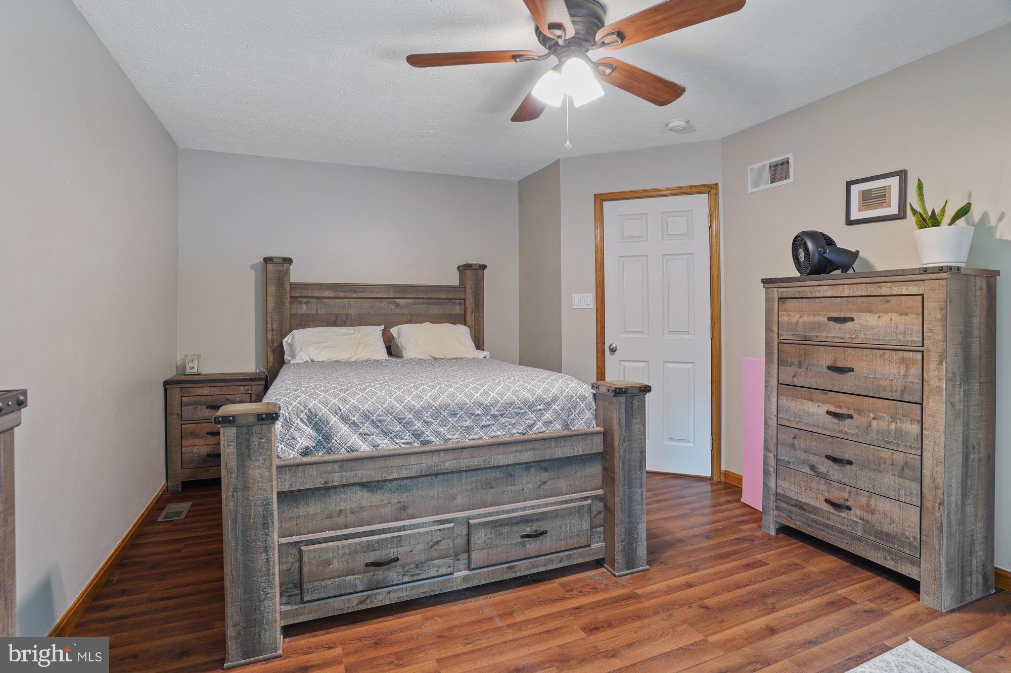 570 Conowingo Road Conowingo, MD 21918 - Photo 16 of 29 a bedroom with a bed and a chandelier