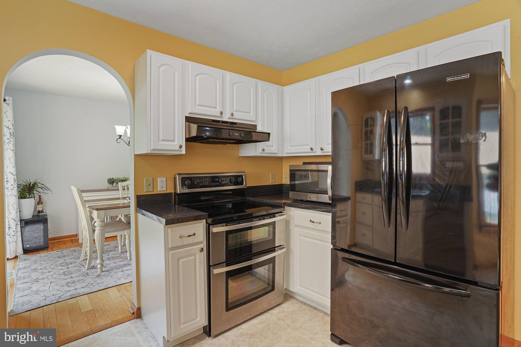 570 Conowingo Road Conowingo, MD 21918 - Photo 9 of 29 a kitchen with stainless steel appliances a sink stove and refrigerator