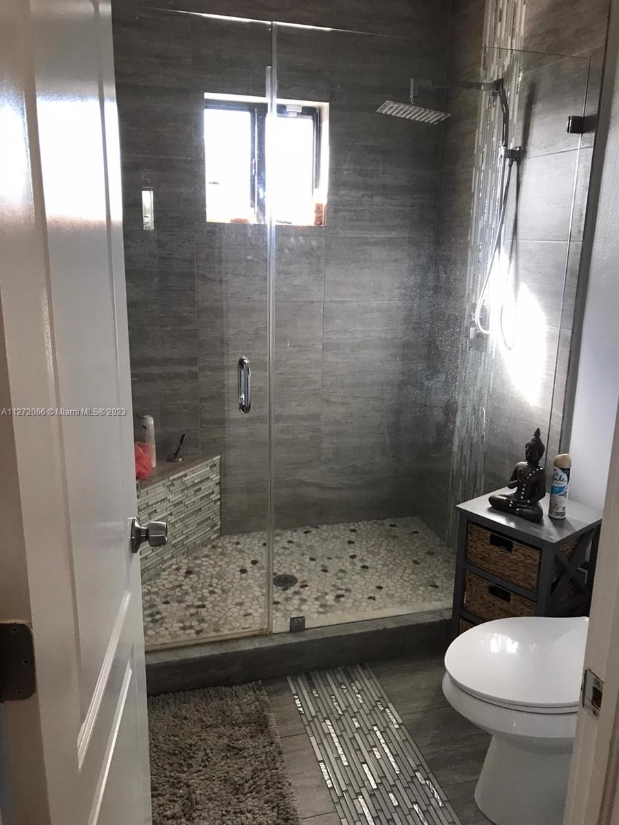 11115 West Okeechobee Road, Unit 176 Hialeah Gardens, FL 33018 - Photo 3 of 12 a bathroom with a sink toilet and shower
