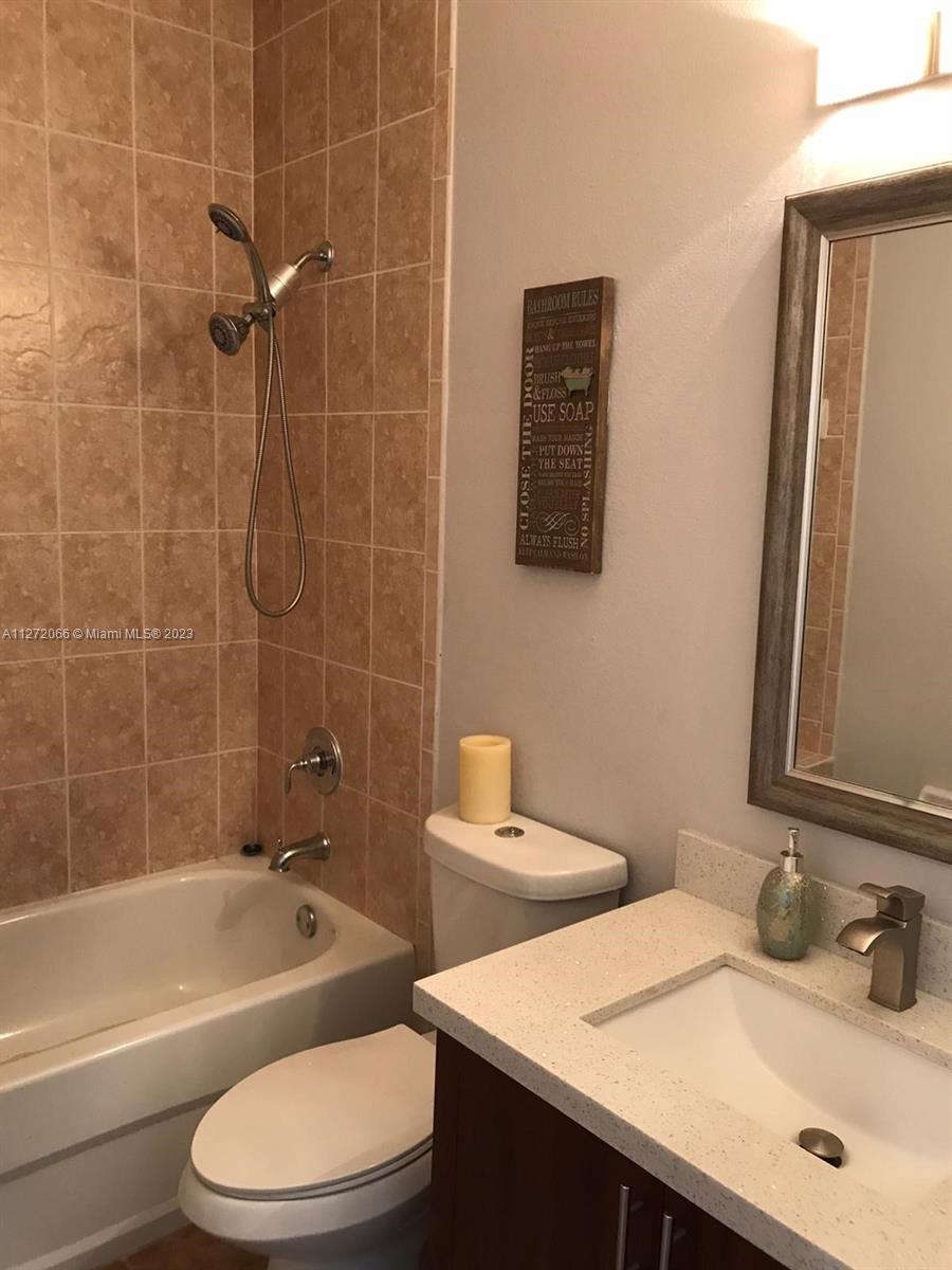11115 West Okeechobee Road, Unit 176 Hialeah Gardens, FL 33018 - Photo 7 of 12 a bathroom with a sink toilet vanity and shower