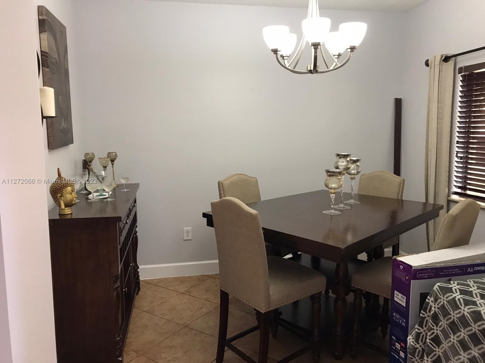 11115 West Okeechobee Road, Unit 176 Hialeah Gardens, FL 33018 - Photo 8 of 12 a view of a dining room with furniture