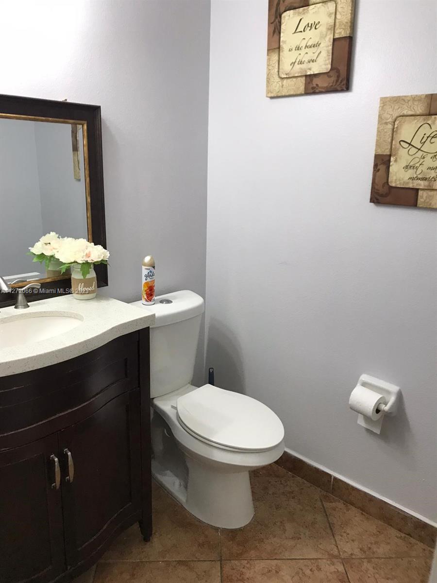 11115 West Okeechobee Road, Unit 176 Hialeah Gardens, FL 33018 - Photo 9 of 12 a bathroom with a sink mirror and toilet