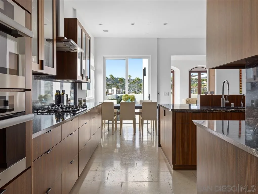7970 Roseland Drive La Jolla, CA 92037 - Photo 14 of 23 a large white kitchen with lots of counter top space