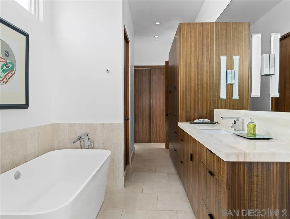 7970 Roseland Drive La Jolla, CA 92037 - Photo 18 of 23 a bathroom with a tub sink and mirror