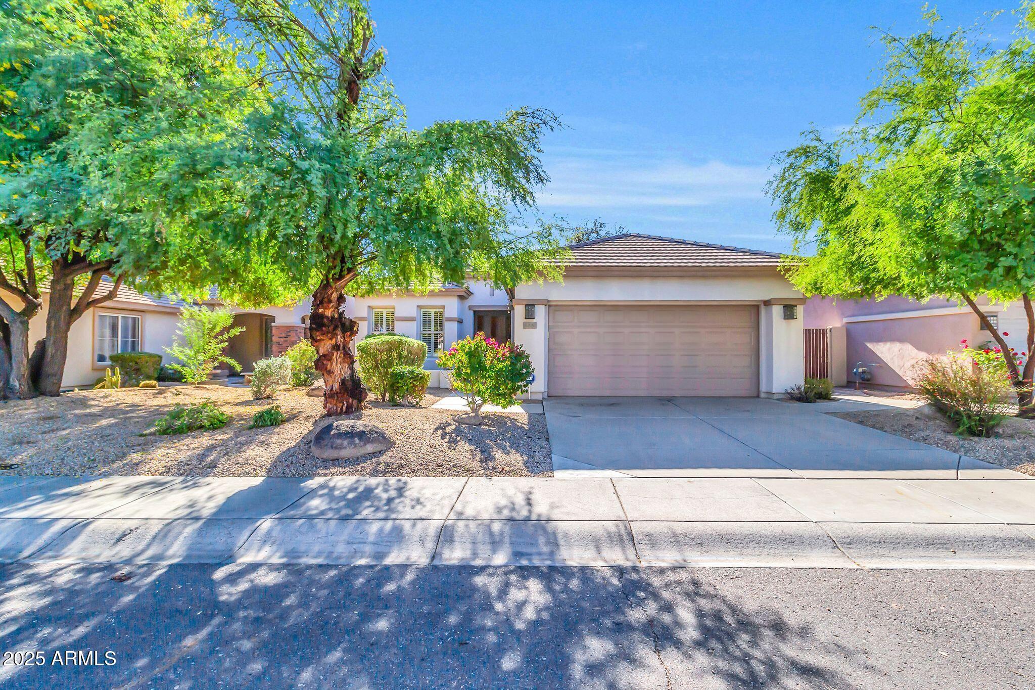 a front view of a house with a yard and a garage
