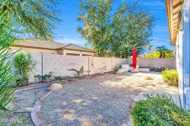 a front view of a house with a yard and potted plants