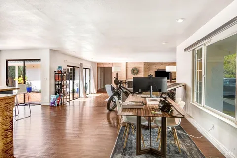 a view of a dining room with furniture window and wooden floor