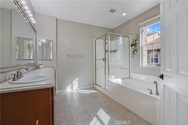 a spacious bathroom with a bathtub shower sink and mirror