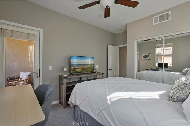 a bedroom with a bed and a tv on a dresser