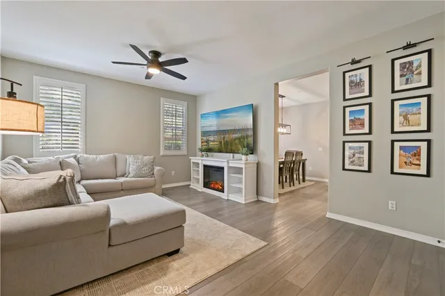 a living room with furniture flat screen tv and a fireplace