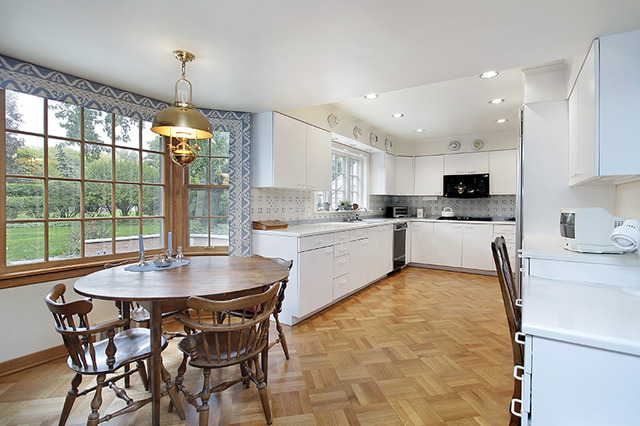 45 Longmeadow Road Winnetka, IL 60093 - Photo 4 of 9 a kitchen with a table chairs microwave and cabinets