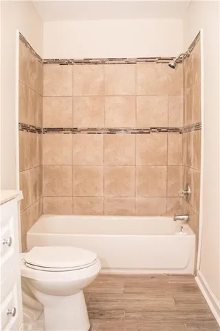 a bathroom with a bathtub and a toilet