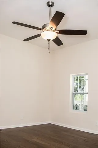 a view of a room with wooden floor and fan
