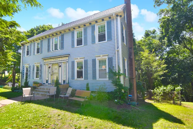 a front view of house with a garden