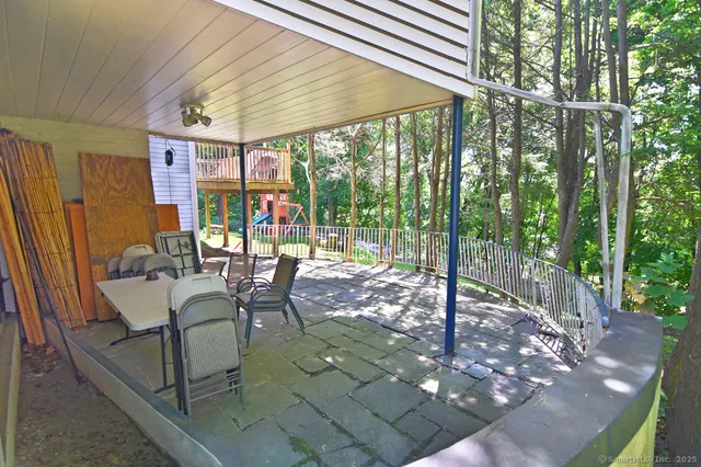 a view of a patio with a table chairs and backyard