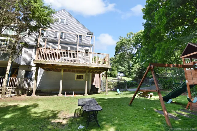 a backyard of a house with table and chairs