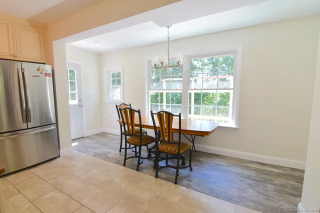a view of a dining room with furniture window and outside view