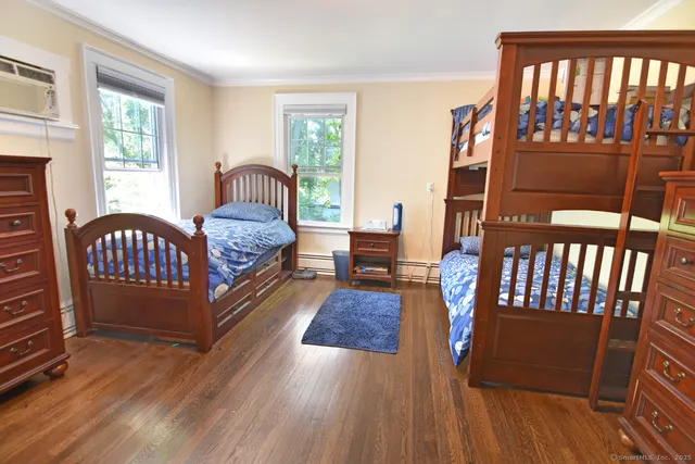 a bedroom with furniture and a window
