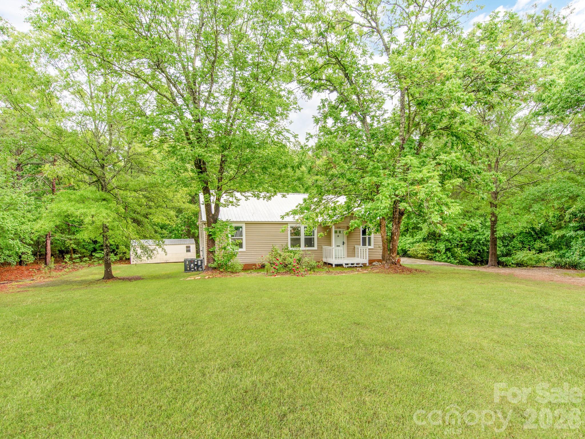 4699 Cherrystone Road Lancaster, SC 29720 - Photo 2 of 28 a view of a house with a big yard and large trees