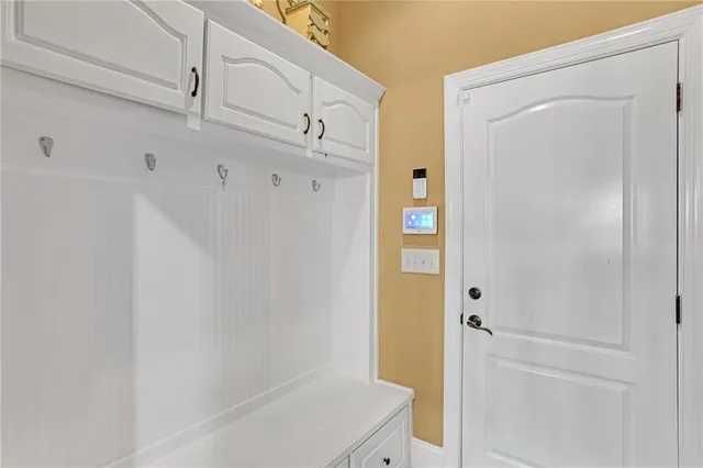 a spacious bedroom with a bed and a flat screen tv