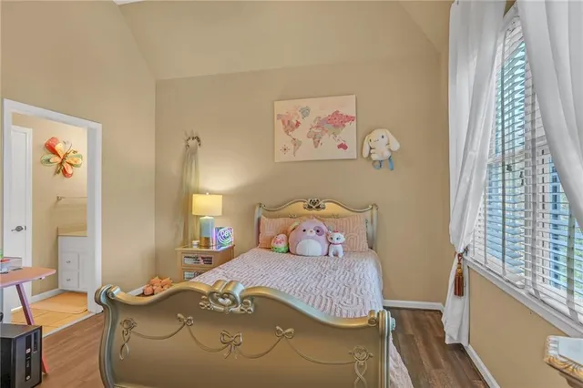 a kitchen with a sink a refrigerator and wooden cabinets