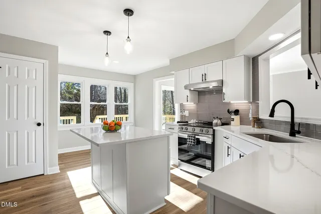 a kitchen with a sink cabinets and stainless steel appliances