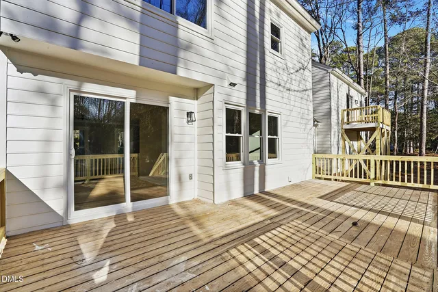 a view of balcony with wooden floor and fence