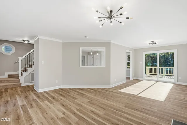 a view of an empty room with a fireplace and a window
