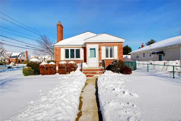 a view of a house with a yard covered in snow