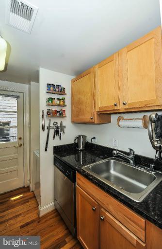 a kitchen with granite countertop a sink and a stove top oven
